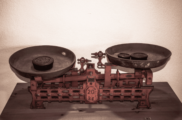 De weegschaal staat voor het meten van de balans tussen ruimte en kaders, geven en nemen in de organisatiedynamiek